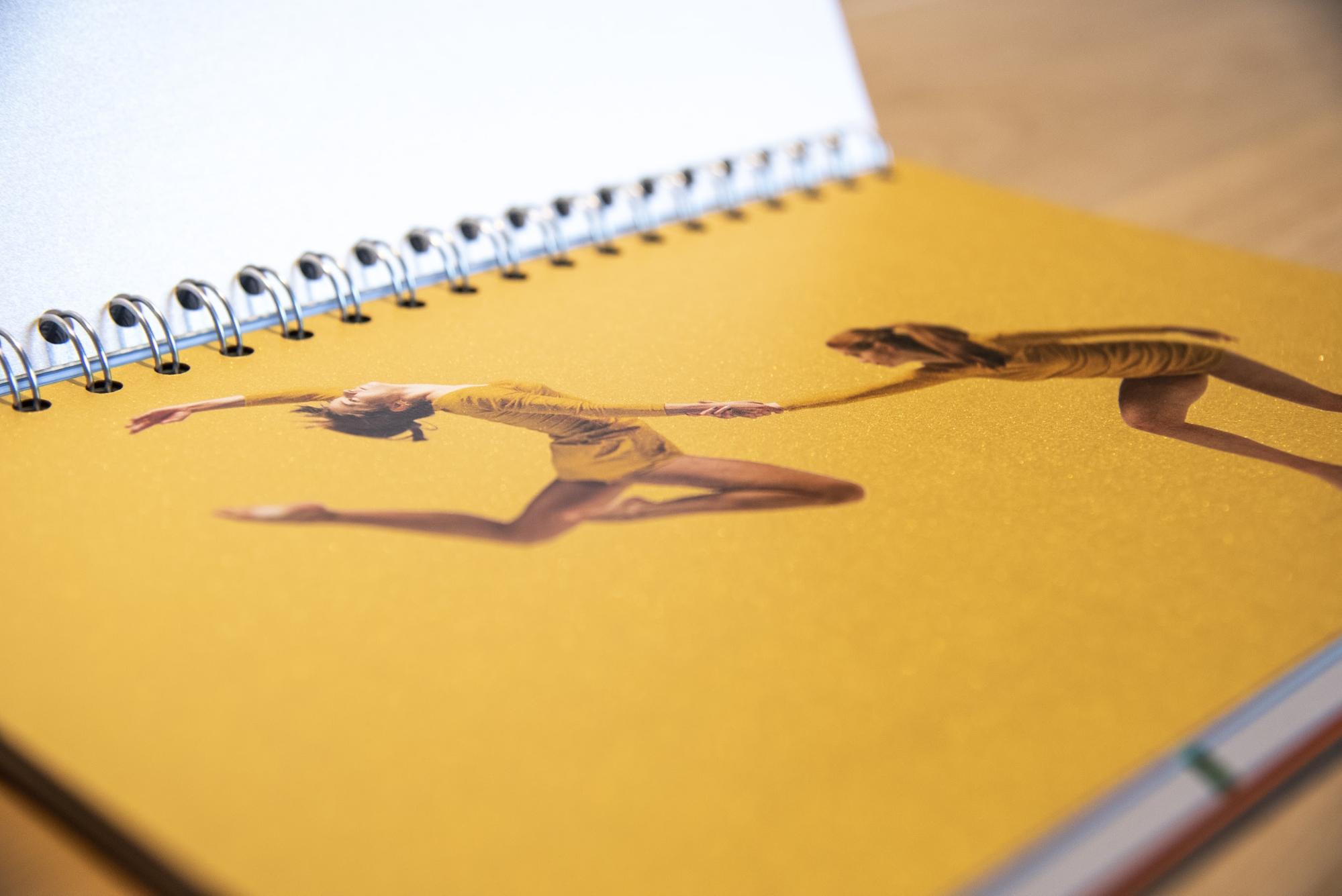 metallic ink example of two gymnasts on yellow background