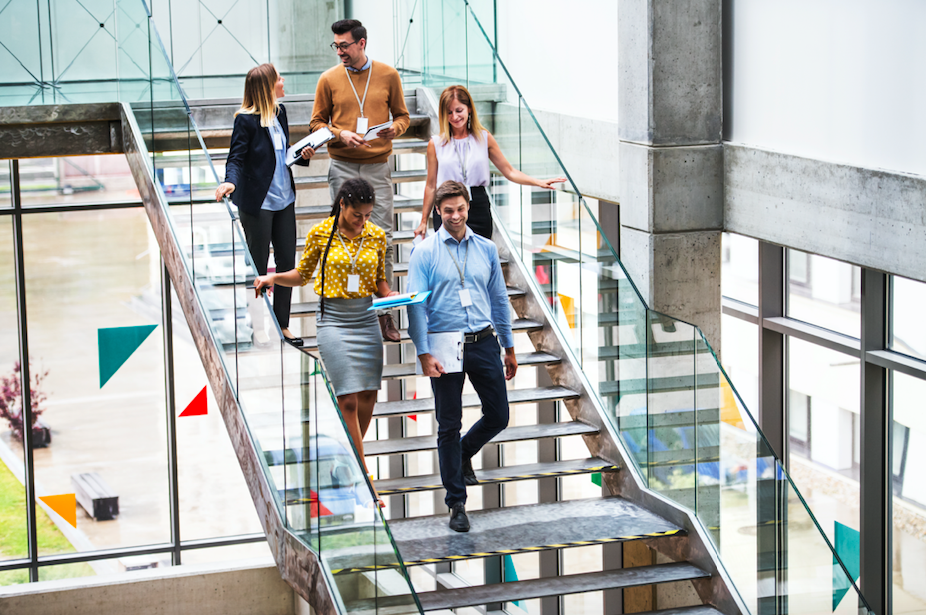 image of employees walking down the stairs in a modern office