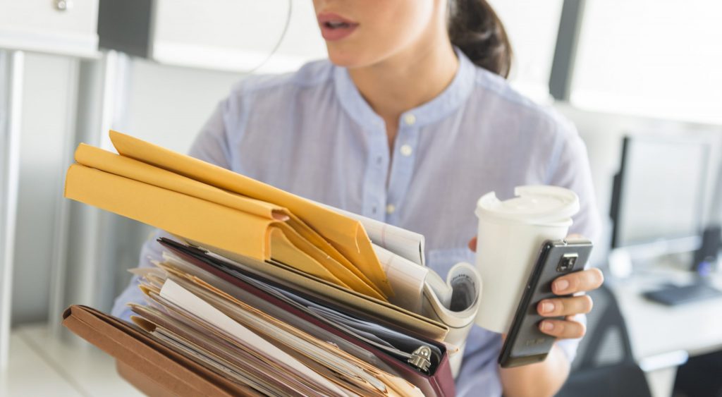 Busy woman holding folders